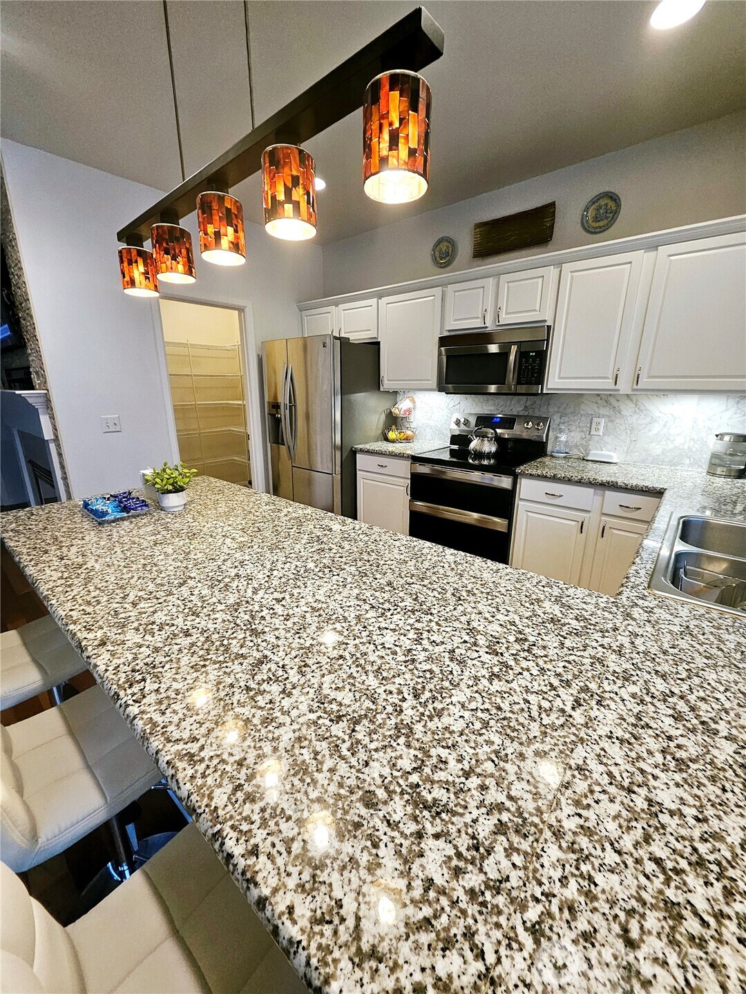 3259 Destination Avenue East Fife, WA 98424 - Photo 5 of 33 a kitchen with stainless steel appliances kitchen island granite countertop a stove and cabinets