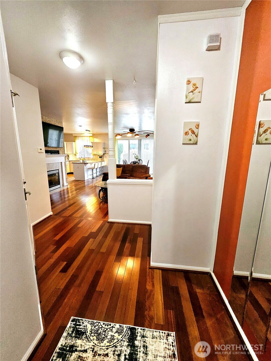 3259 Destination Avenue East Fife, WA 98424 - Photo 9 of 33 a hallway with a large kitchen island wooden floor and a stove top oven