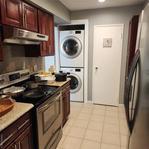 a kitchen with stainless steel appliances granite countertop a stove top oven a sink and dishwasher