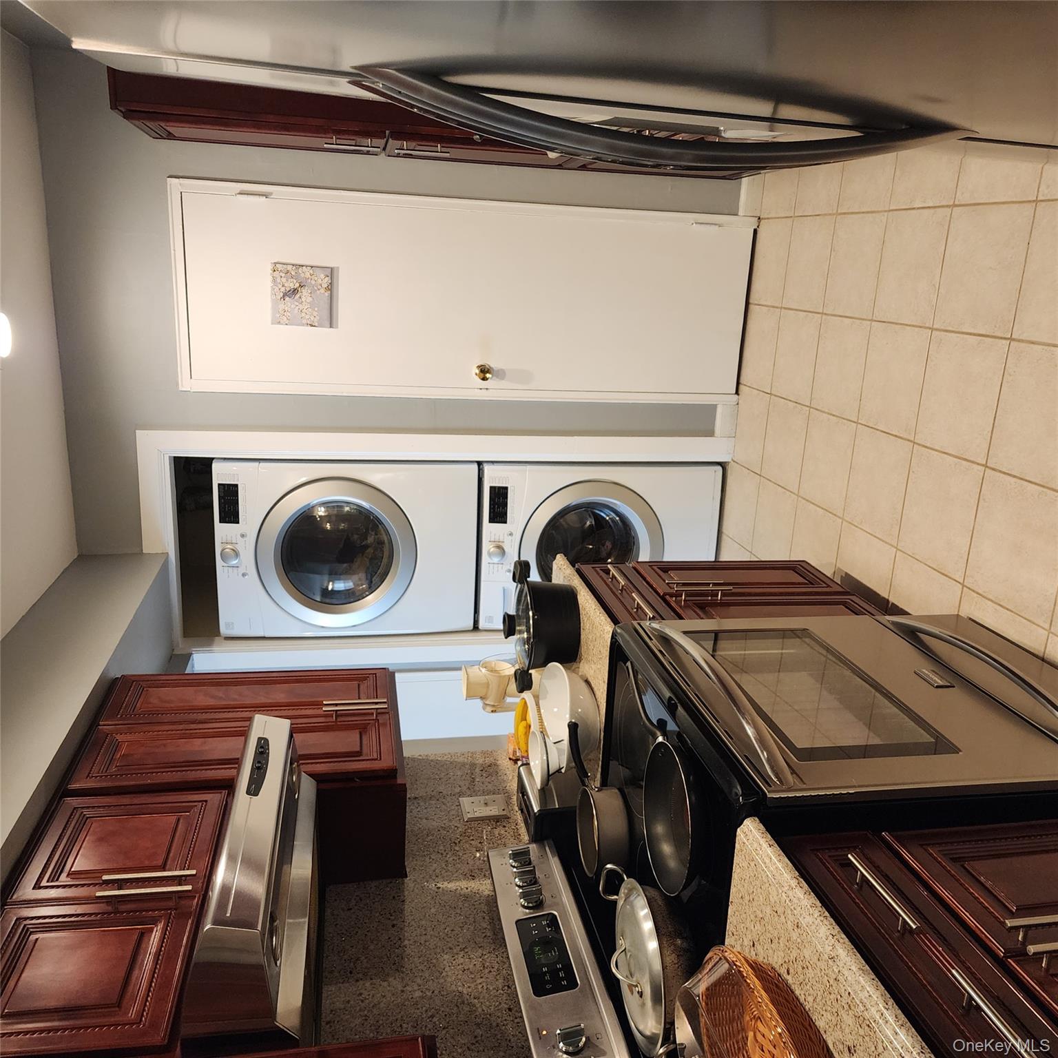 2 D Valley Forge Court Ridge, NY 11961 - Photo 12 of 13 a kitchen with stainless steel appliances granite countertop a stove top oven a sink and dishwasher