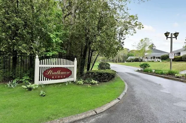 a front view of a house with a garden and swing