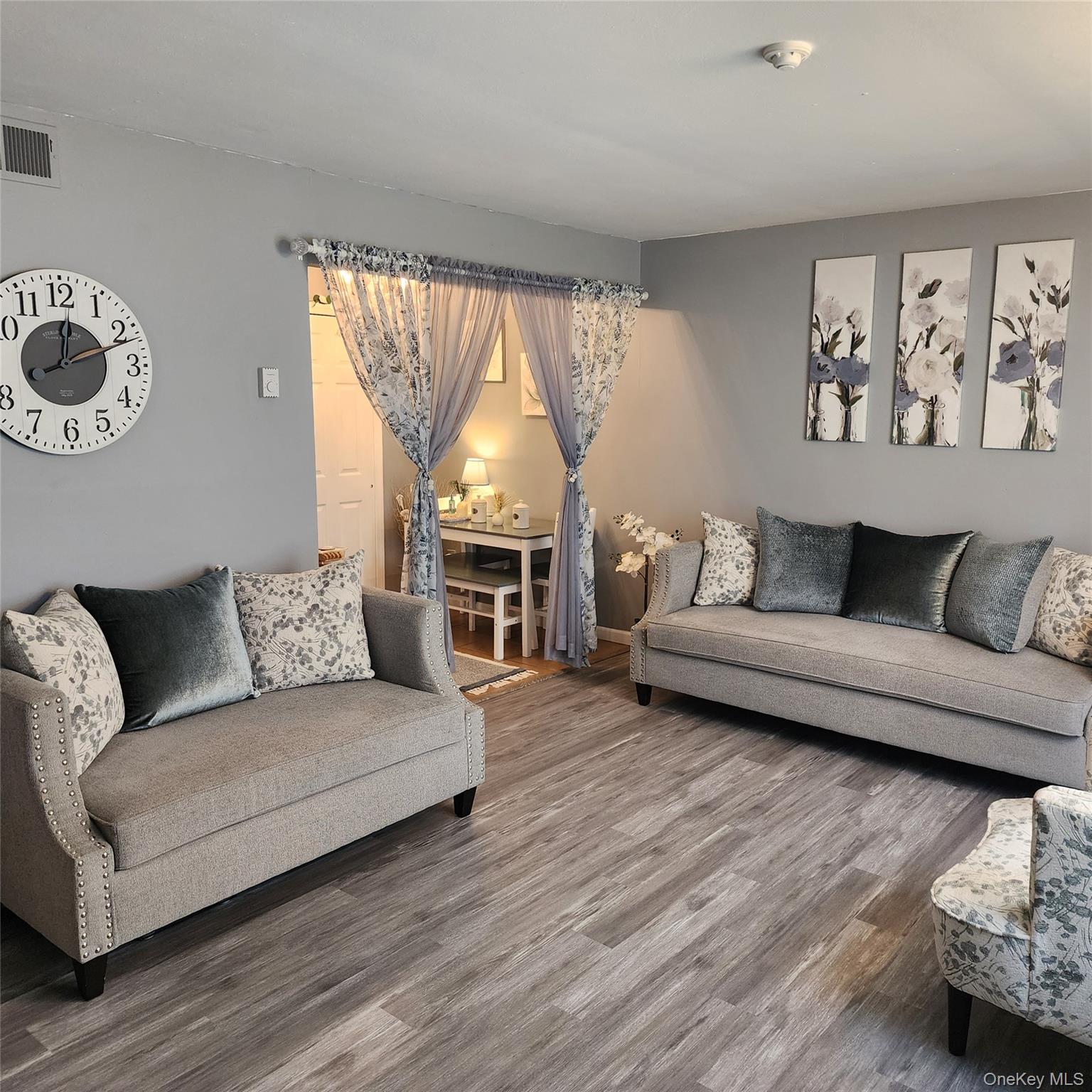 2 D Valley Forge Court Ridge, NY 11961 - Photo 2 of 13 a living room with furniture and a large window