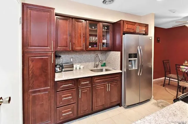 a kitchen with stainless steel appliances granite countertop a refrigerator and a sink