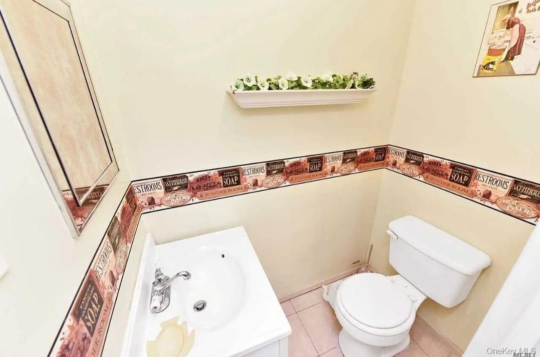 2 D Valley Forge Court Ridge, NY 11961 - Photo 7 of 13 a bathroom with a toilet and a sink