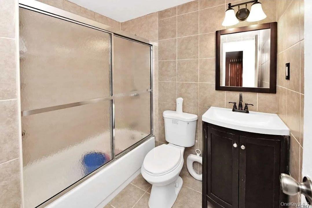 2 D Valley Forge Court Ridge, NY 11961 - Photo 8 of 13 a bathroom with a sink and a mirror