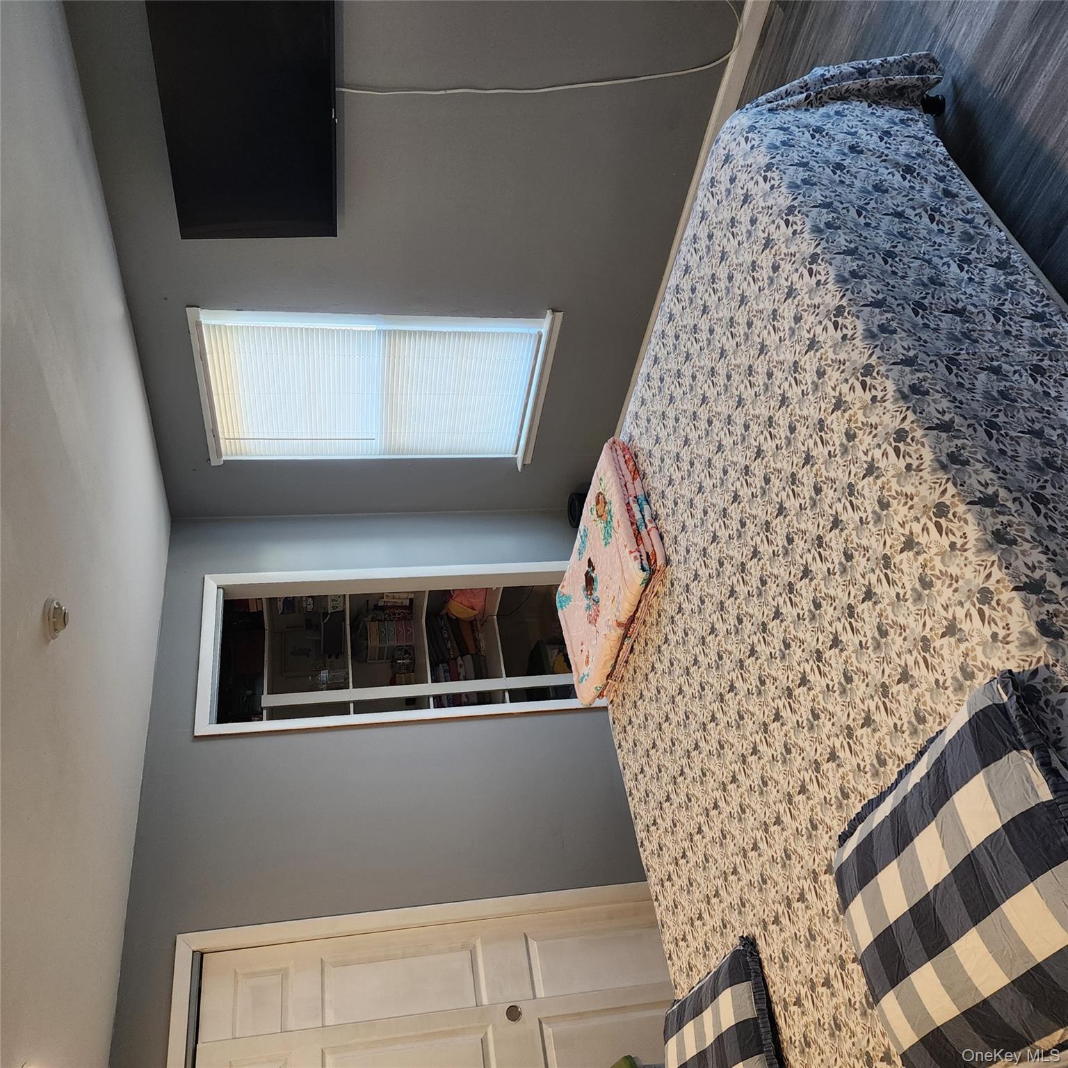 2 D Valley Forge Court Ridge, NY 11961 - Photo 10 of 13 a bedroom with a bed and a flat screen tv