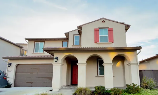 a front view of a house with garage