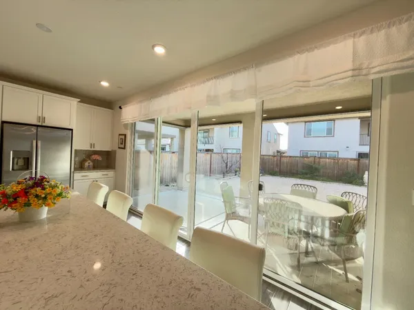 a room with lots of white furniture and shower