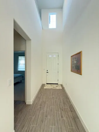 an empty room with wooden floor and closet