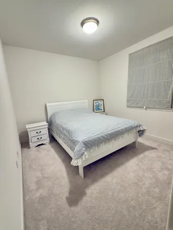 a bedroom with a bed and a cabinets