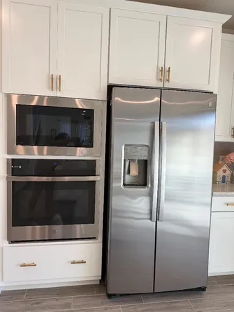 a kitchen with a refrigerator and a microwave