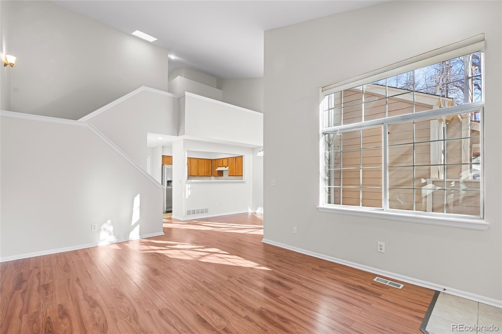 6828 Zenobia Street, Unit 2 Westminster, CO 80030 - Photo 3 of 24 a view of empty room with wooden floor and fan