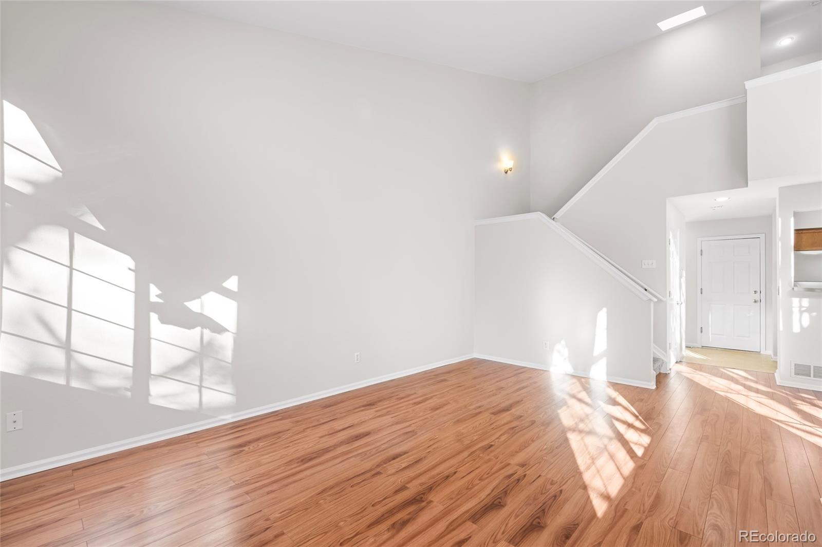 6828 Zenobia Street, Unit 2 Westminster, CO 80030 - Photo 7 of 24 a view of empty room with wooden floor and fan