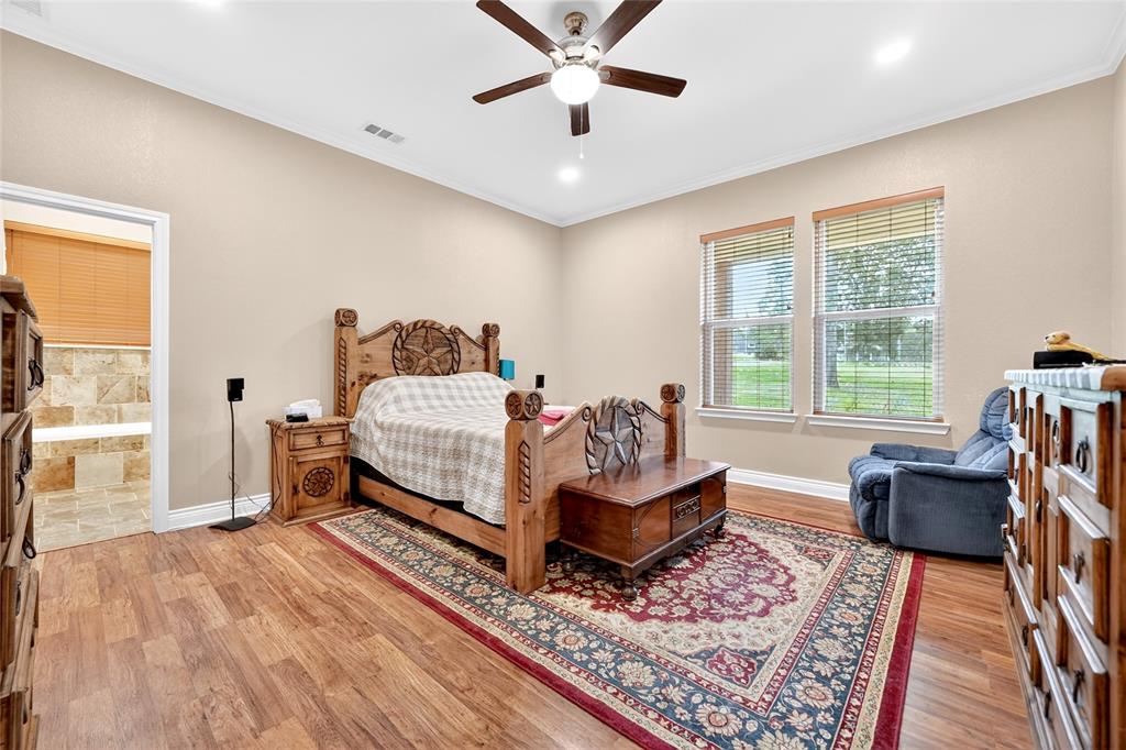 5230 Esquire Estates Road Mabank, TX 75156 - Photo 22 of 39 Spacious bedroom featuring wood-finish flooring, two large windows with blinds, a ceiling fan, and recessed lighting