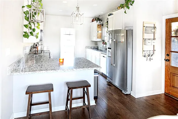 a kitchen with refrigerator and window