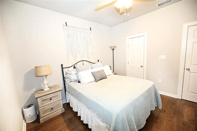 a view of a hallway with wooden floor and entryway
