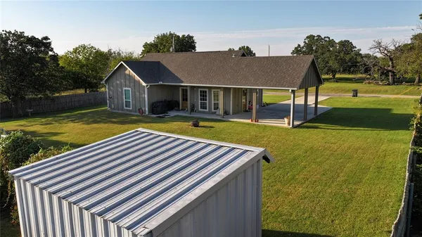 a view of a house with pool and a yard