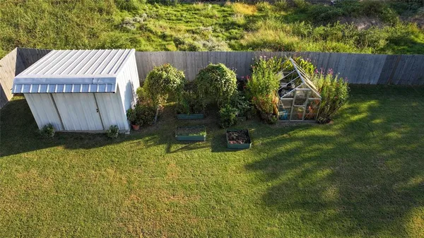 a view of a backyard with plants and outdoor seating