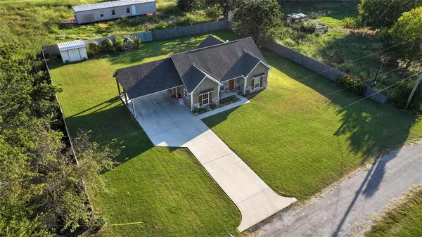 a view of house with backyard and garden