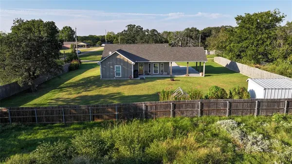 aerial view of a house with a yard