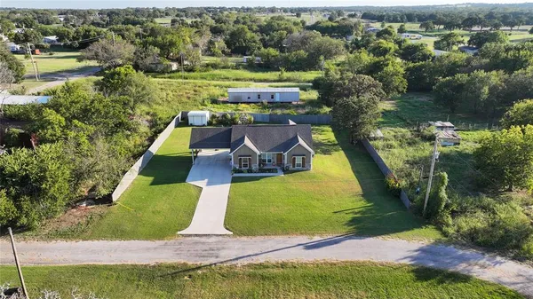 an aerial view of a house with a yard