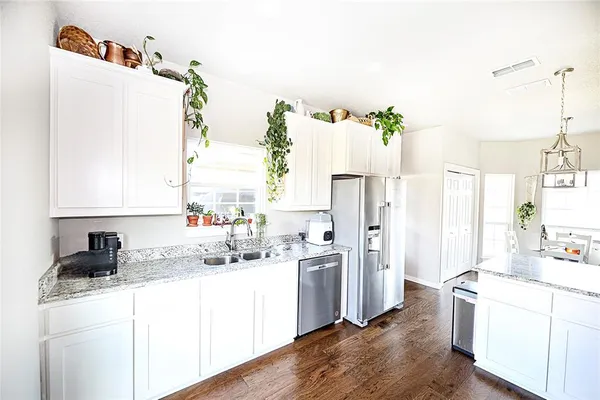 a kitchen with stainless steel appliances a refrigerator and a stove top oven