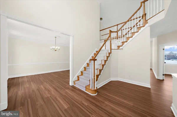 a view of entryway and hall with wooden floor