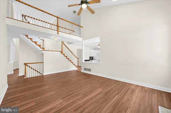 a view of a room with wooden floor and small window