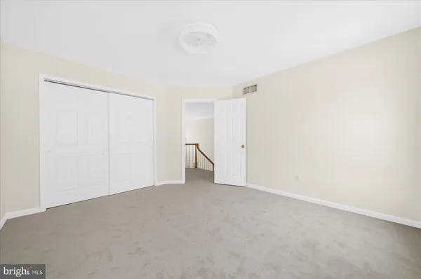 a view of a livingroom with a ceiling fan and window