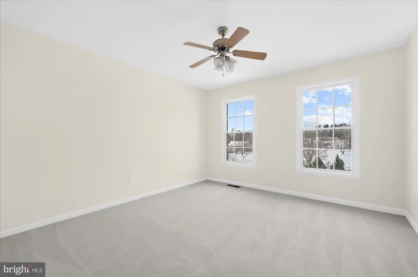 a view of a room with wooden floor and a couch