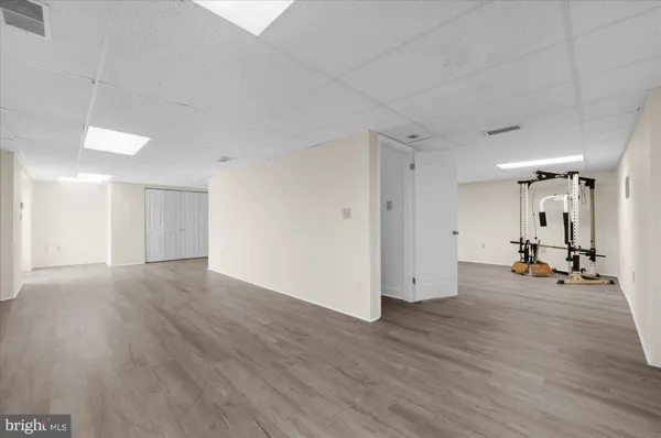 a view of a room with wooden floor and a sink