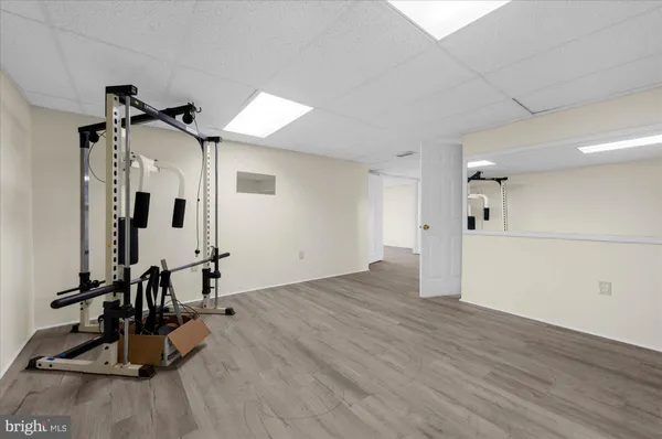 an empty room with wooden floor and natural light