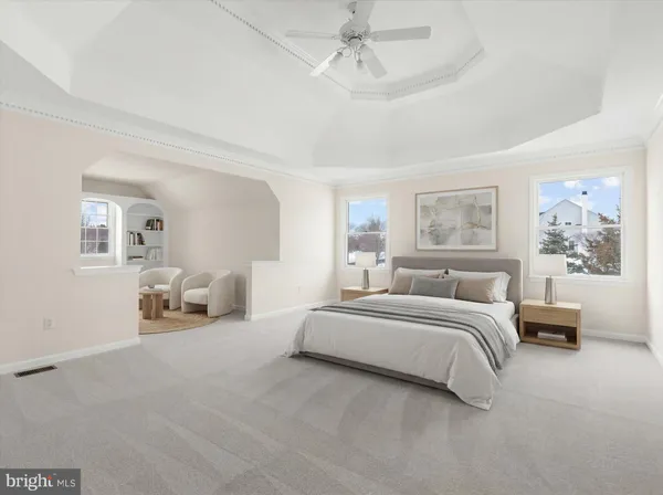 a spacious bedroom with a bed and ceiling fan