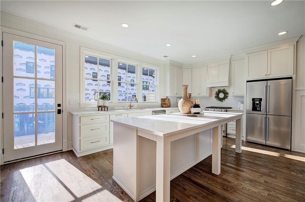178 West Main Street, Unit 102 Cartersville, GA 30120 - Photo 18 of 50 a kitchen with a sink a stove a refrigerator and white cabinets