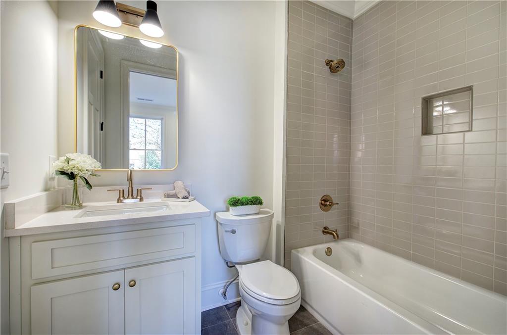 178 West Main Street, Unit 102 Cartersville, GA 30120 - Photo 10 of 50 a bathroom with a toilet a sink a mirror a bathtub and vanity
