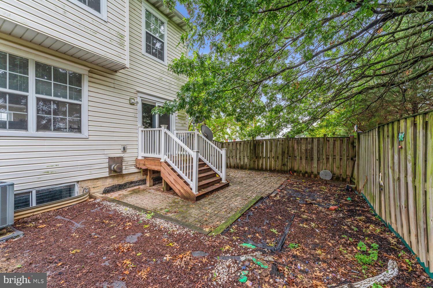 6817 Signature Circle Alexandria, VA 22310 - Photo 13 of 25 a view of a small house with wooden fence