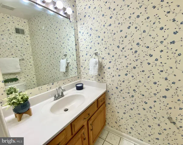 a bathroom with a sink a mirror and shower