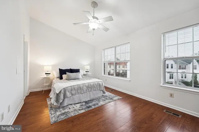 a bedroom with a large bed chandelier and a window