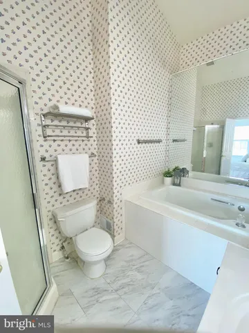 a white toilet sitting next to a bathroom sink