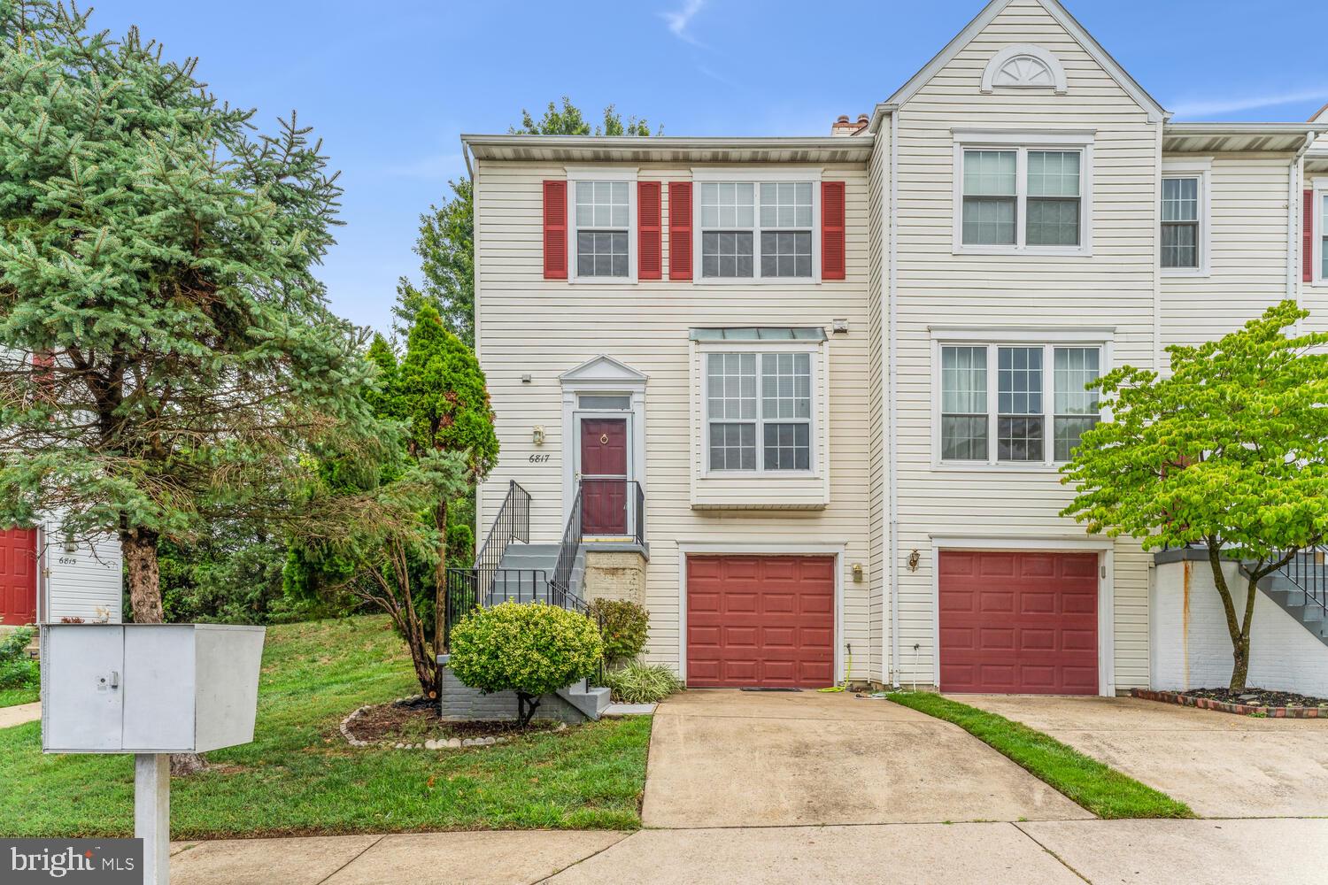 6817 Signature Circle Alexandria, VA 22310 - Photo 3 of 25 a front view of a house with a yard and trees