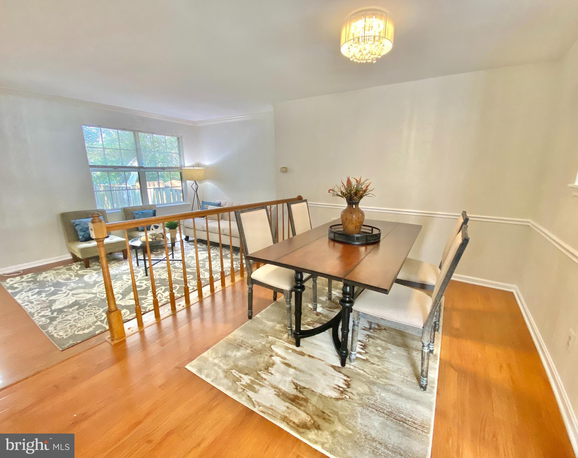 6817 Signature Circle Alexandria, VA 22310 - Photo 7 of 25 a view of a dining room with furniture a rug and wooden floor