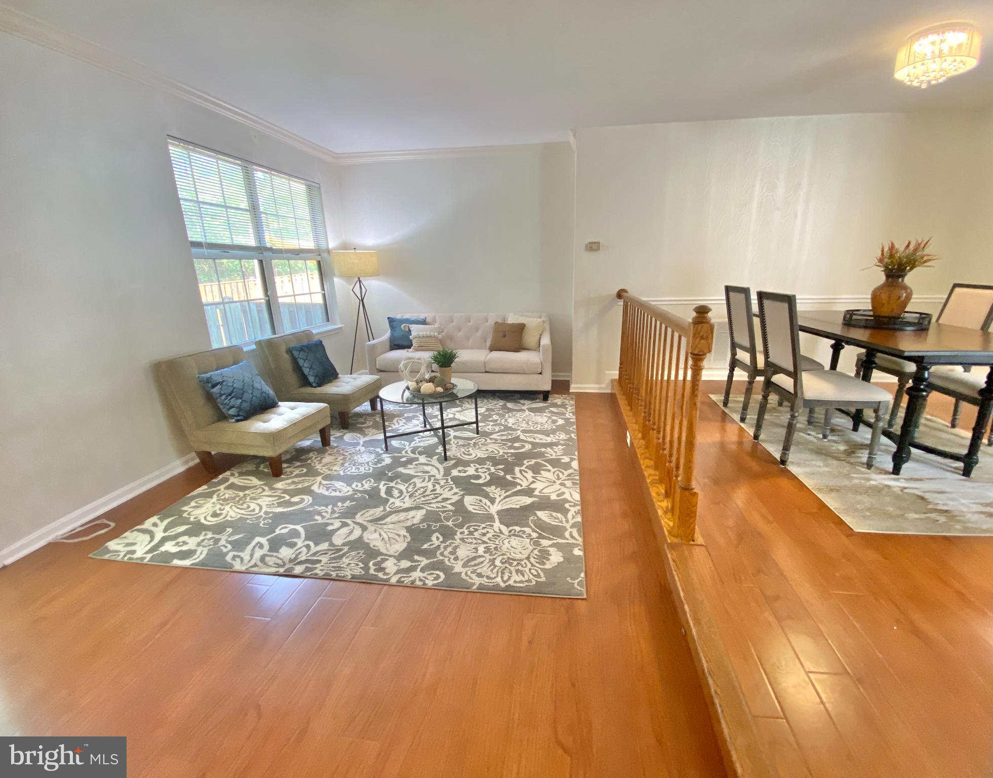 6817 Signature Circle Alexandria, VA 22310 - Photo 9 of 25 a living room with dining room and wooden floor