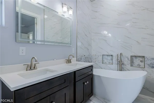 a bathroom with a bathtub and a sink