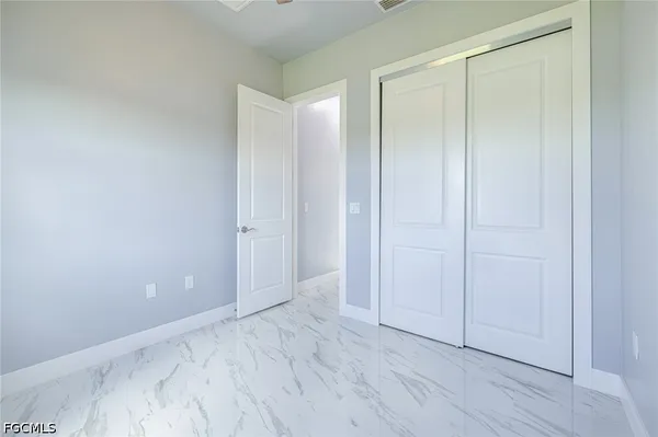 a view of an empty room and wooden floor