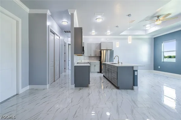 a large kitchen with a large window and stainless steel appliances