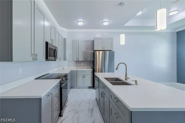 a kitchen with a sink cabinets and stainless steel appliances