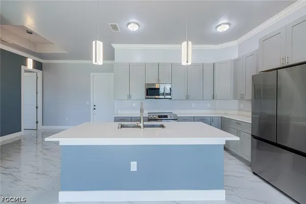 a view of a kitchen with a sink an oven and refrigerator