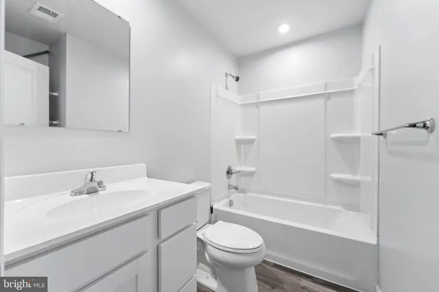 a bathroom with a sink mirror toilet and bathtub