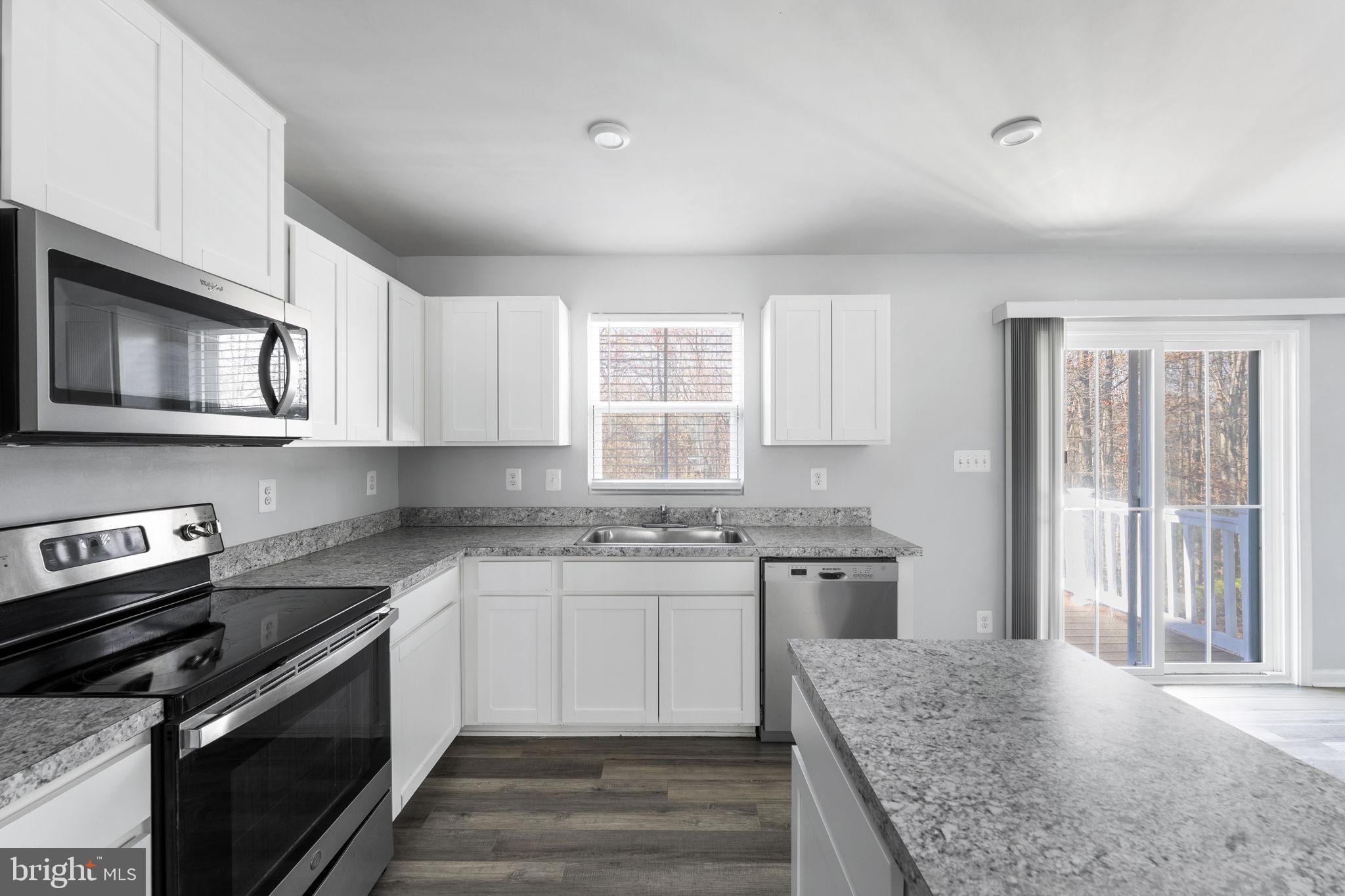 152 Ben Boulevard Elkton, MD 21921 - Photo 4 of 34 a kitchen with stainless steel appliances granite countertop a stove and a sink
