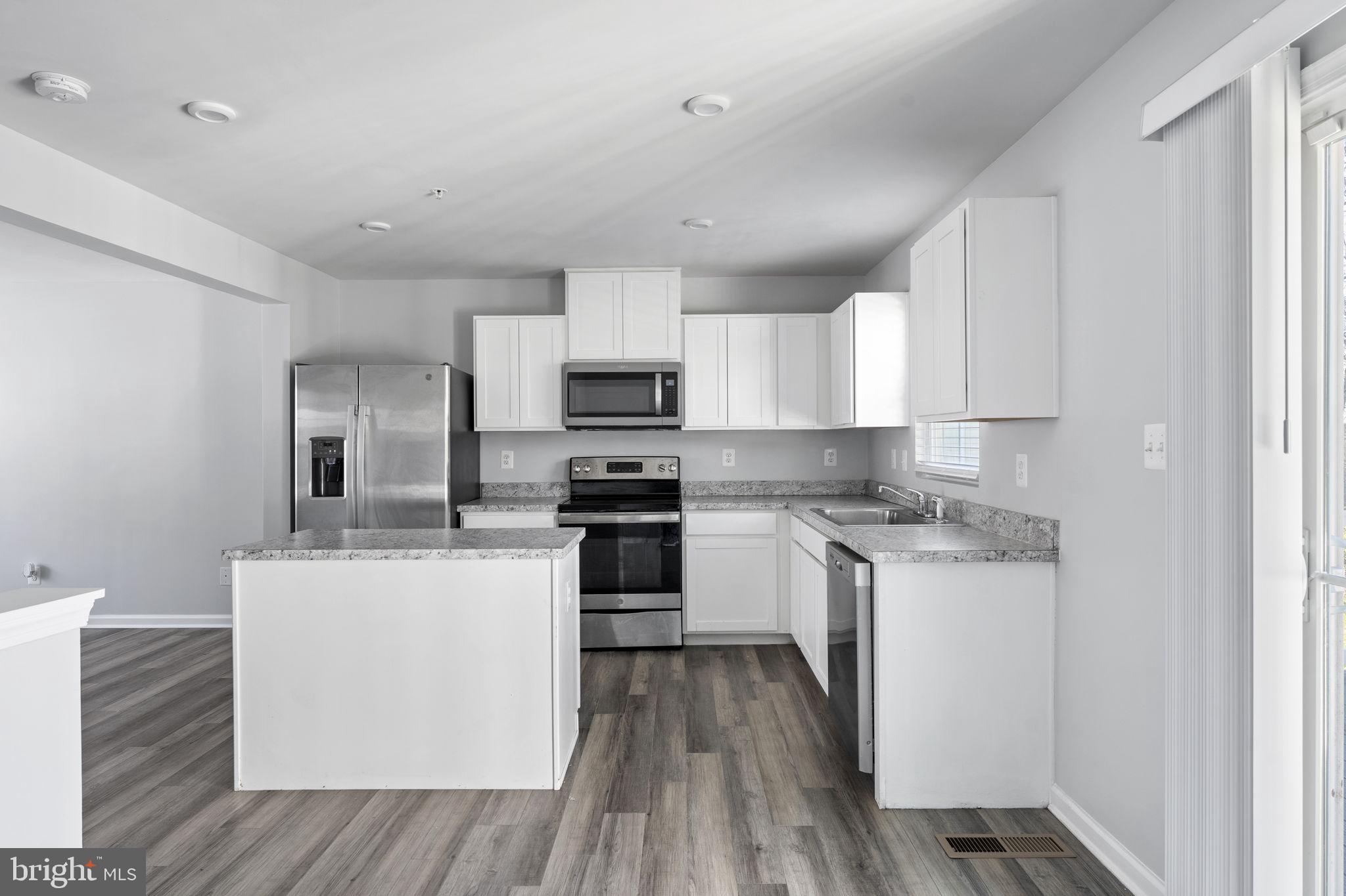 152 Ben Boulevard Elkton, MD 21921 - Photo 5 of 34 a kitchen with a sink a counter top space stainless steel appliances and cabinets